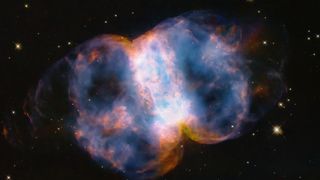 a blue-and-orange cloud of gas in space, roughly shaped like an hourglass