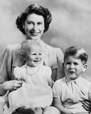 Prince Charles and Princess Anne pose with their mother