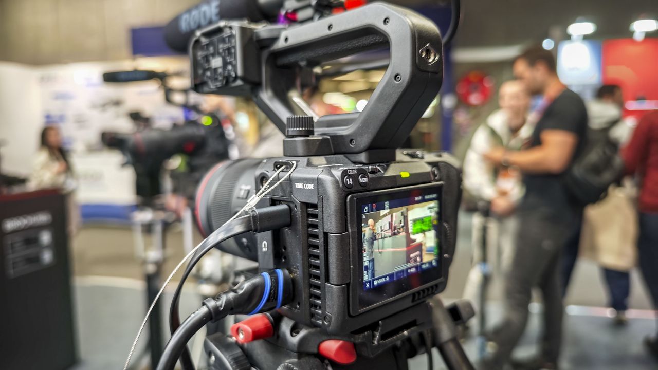 IBC 2025 show &ndash; Canon EOS C50 on a tripod with top handle attached and multiple extenral devices connected
