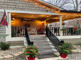 A porch with seating decorated for Christmas