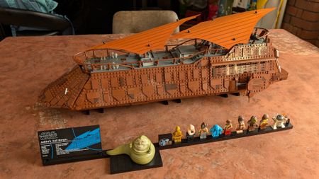 Lego Jabba's Sail Barge, plaque, and minifigures on a dusty desert background