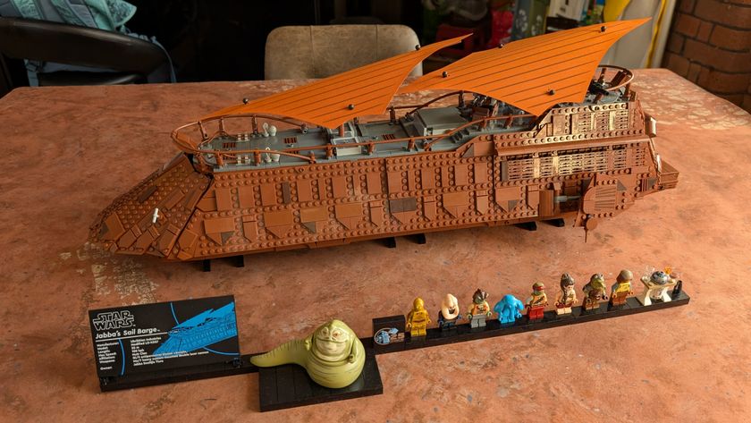 Lego Jabba&#039;s Sail Barge, plaque, and minifigures on a dusty desert background