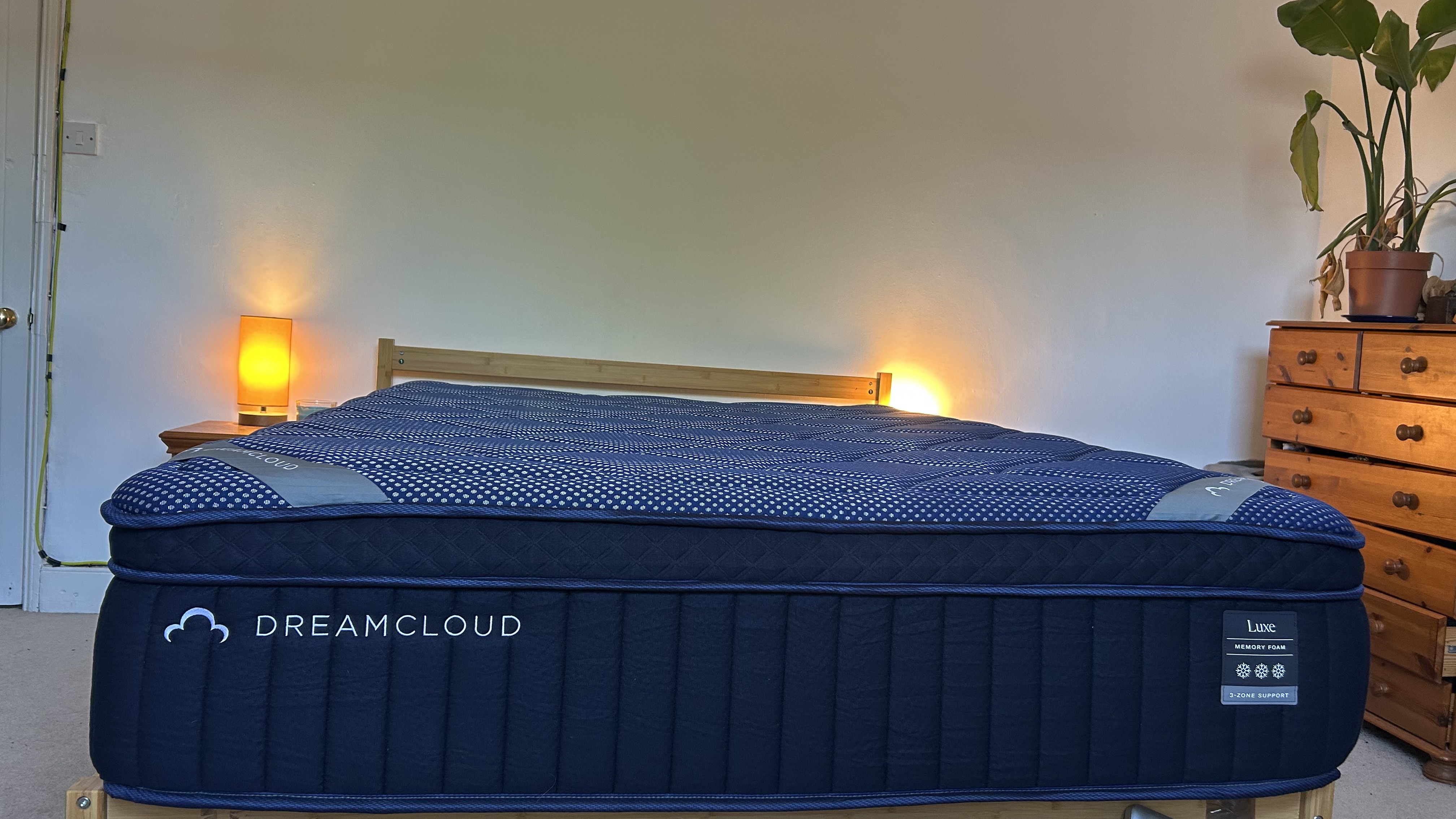 Close detail images of the DreamCloud Luxe Memory Foam mattress, showing design features like the quilted top of the bed and the handles sewn onto the sides