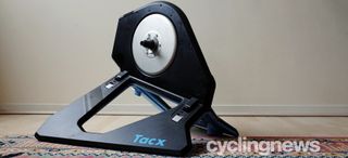 Tacx Neo 2T smart trainer stands in front of a blank wall