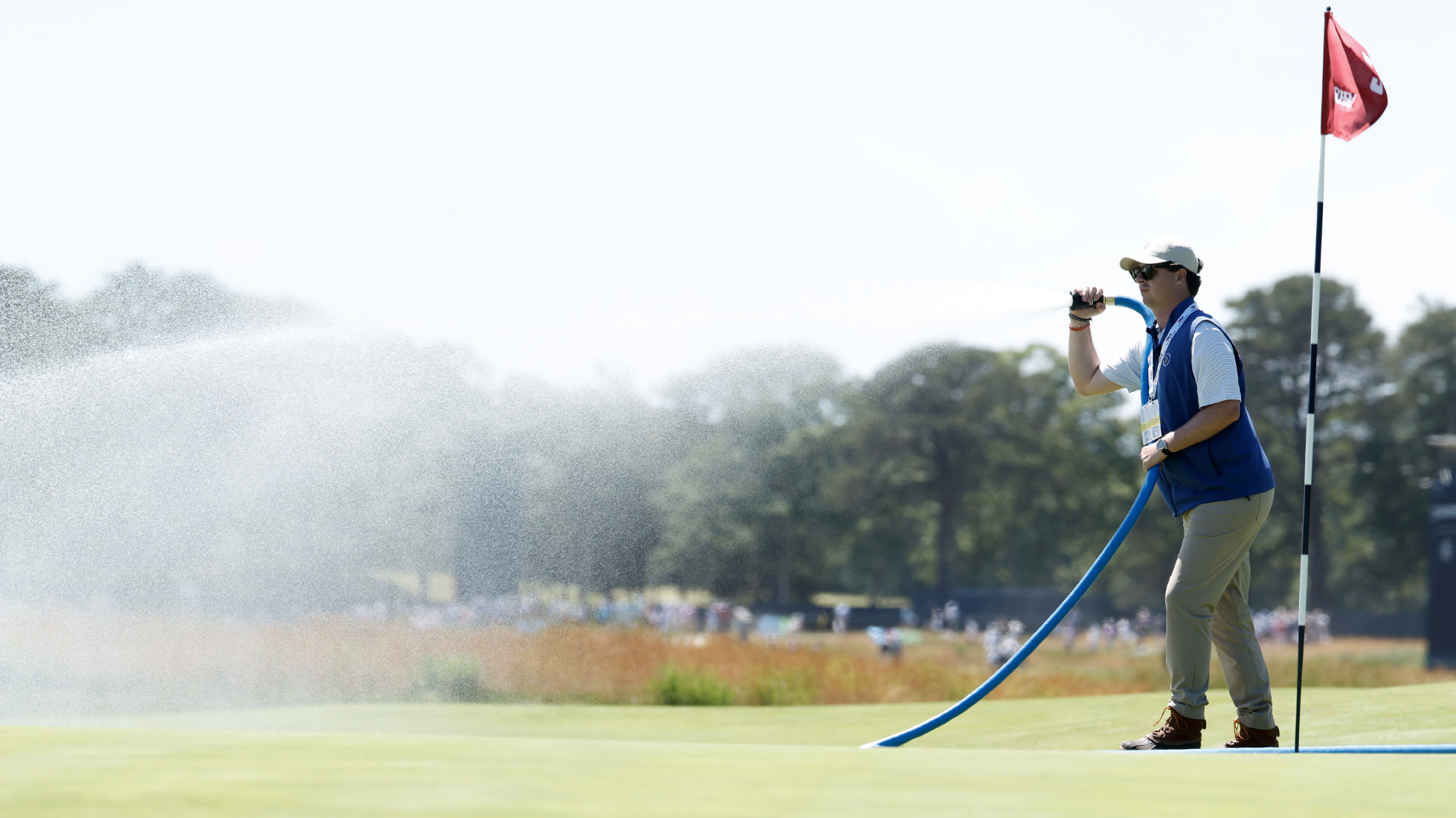 What does syringing the greens in golf mean, which is happening at Shinnecock Hills for the 2026 US Open?