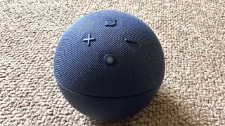 Close up of Amazon Echo Dot (5th gen) speaker on carpet