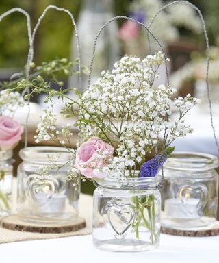 hanging glass tea light holders with cut flowers