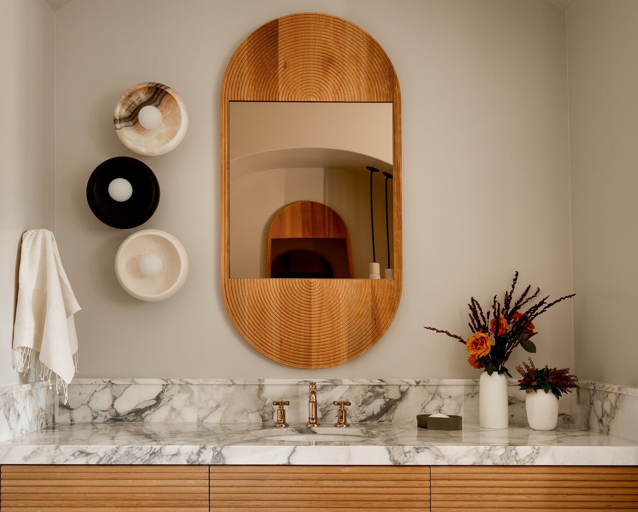 A bathroom lit with a side wall light