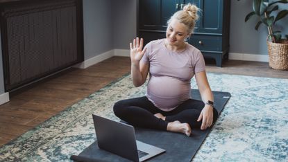 Pregnant woman joins online yoga class from home