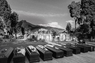 A monochrome photo of a group of coffins in an italian village