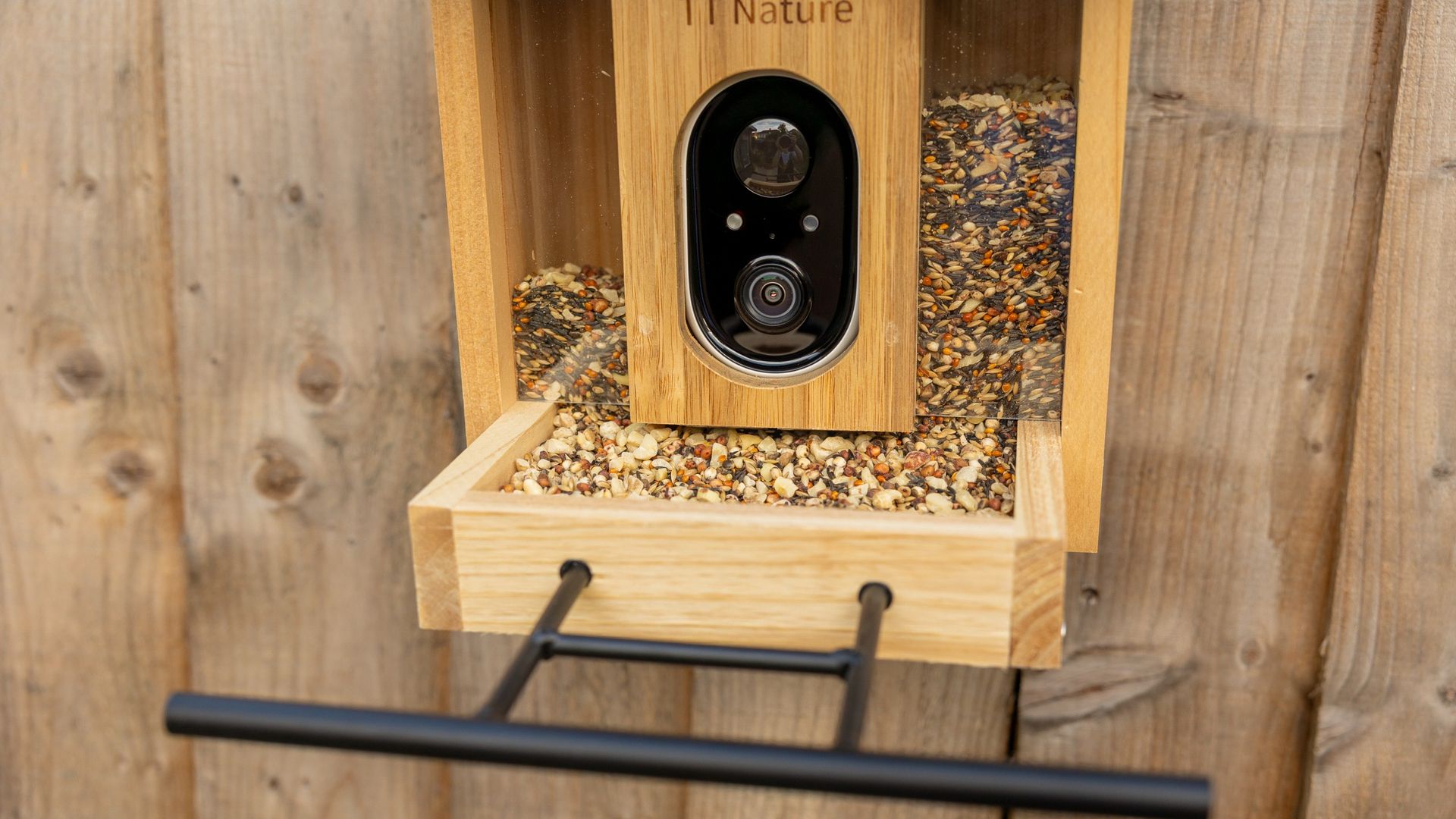 The TT Nature bird feeder camera on a garden fence