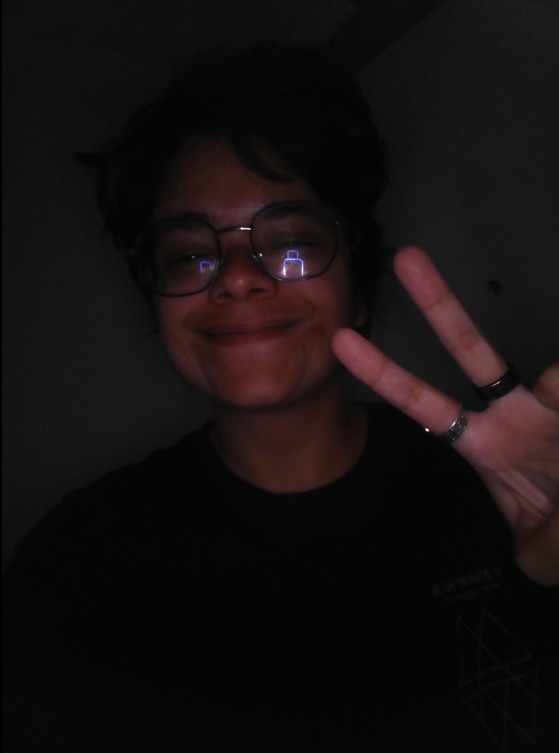 A selfie of a woman with short hair holding up a peace sign with her fingers, taken on a myFirst Camera 50 smartphone camera for 5-12-year-olds