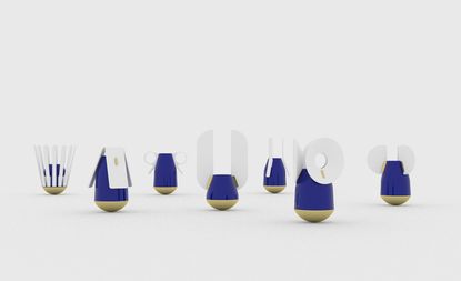 Blue miniature vases with decorative elements in white, photographed against a grey background