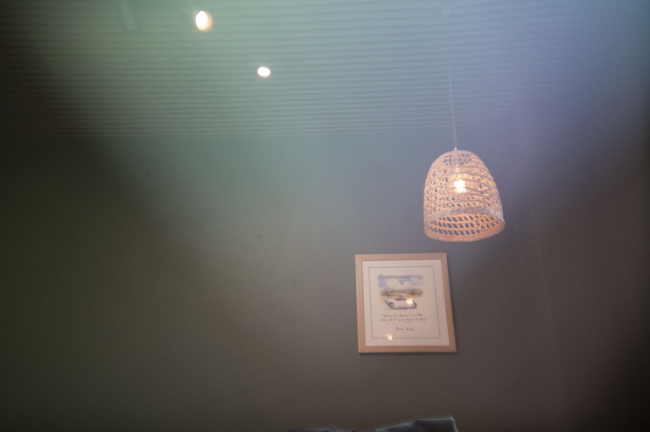 A lamp shade inside a cafe, with light leak effect