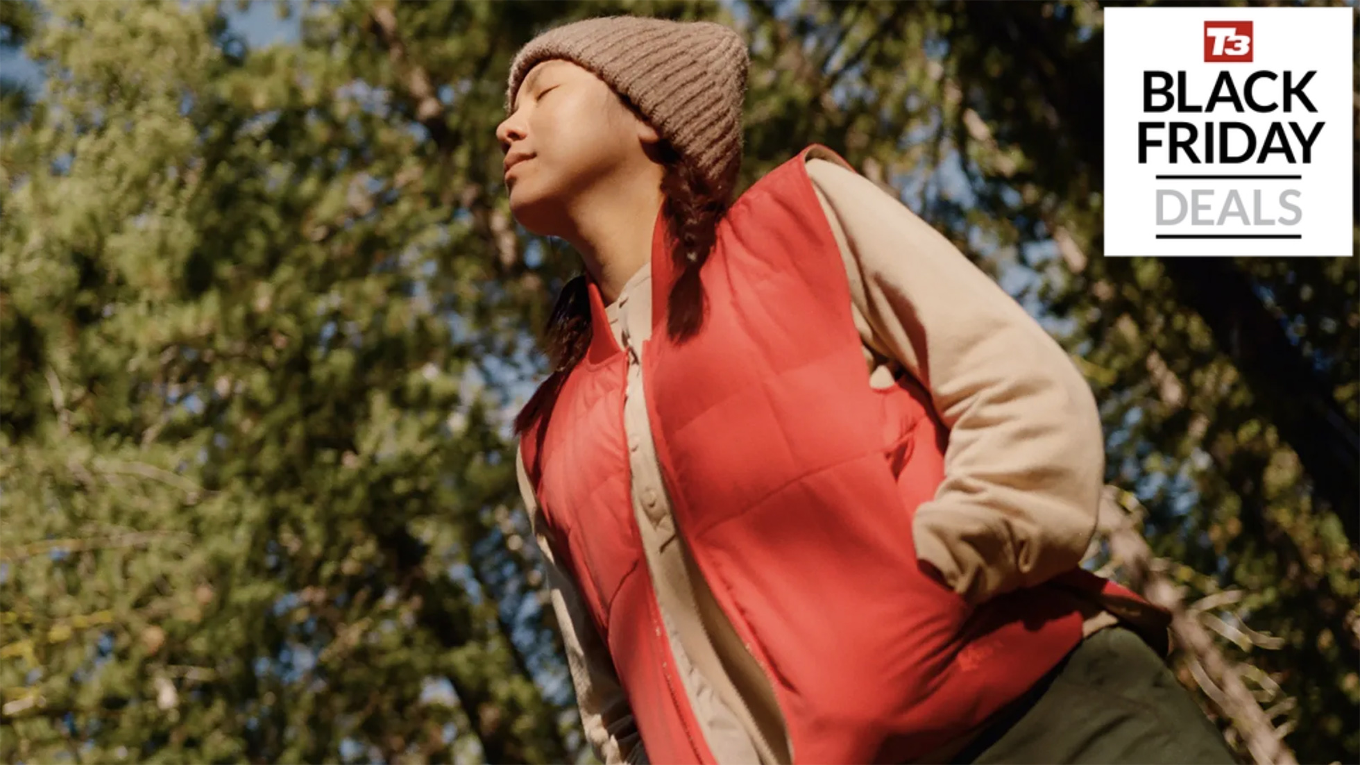 Person standing in a forest in outdoor apparel
