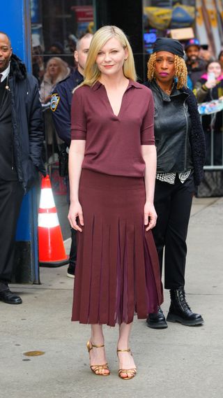 Kristen Dunst wearing burgundy outfit