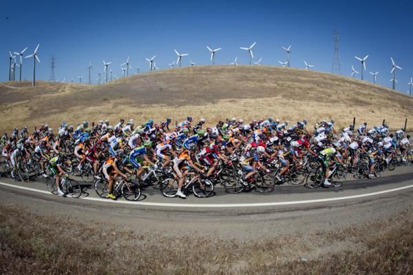 The peloton passes by a wind farm along the route.
