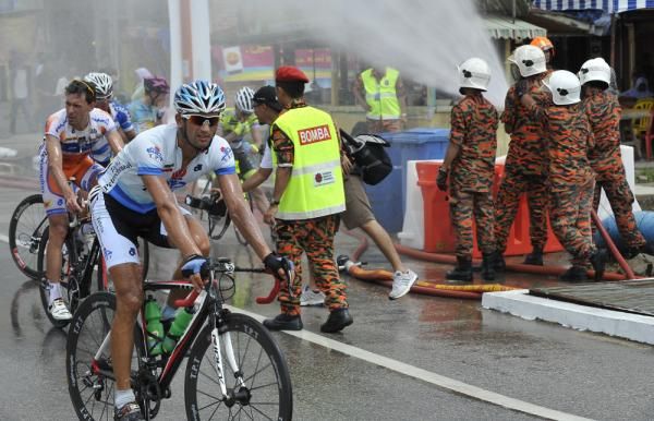 Riders sprayed by a water canon from Bomba Officer after finished at stage 1 TDL 2010, the weather was very hot, almost 40 Celcius degree.