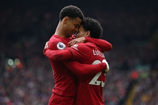 Liverpool's Dutch striker Cody Gakpo (L) celebrates with Liverpool's Colombian midfielder Luis Diaz (R) after Diaz scores their second goal during the English Premier League football match between Liverpool and Tottenham Hotspur at Anfield in Liverpool, north west England on April 30, 2023.