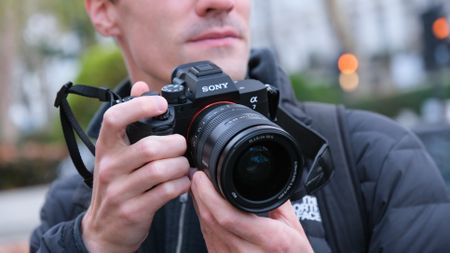 Sony A7 V camera held in a person's hands