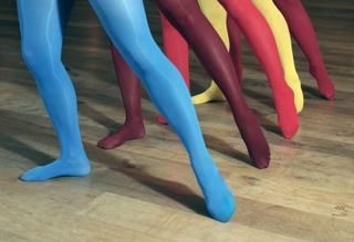Five pairs of legs showing a range of coloured tights