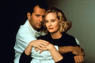 bruce willis and Cybill Shepherd posing in a shot for Moonlighting