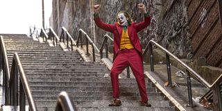 Joaquin Phoenix as Joker dancing on staircase