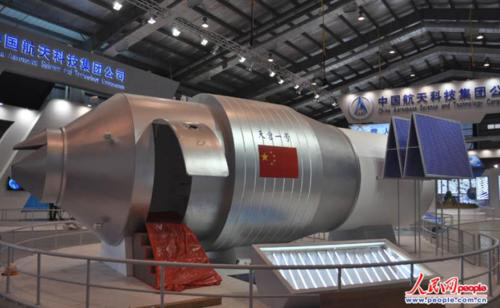 Display model of Tiangong I module at an exhibition hall at the China Academy of Space Technology, complete with access door for public viewing. 