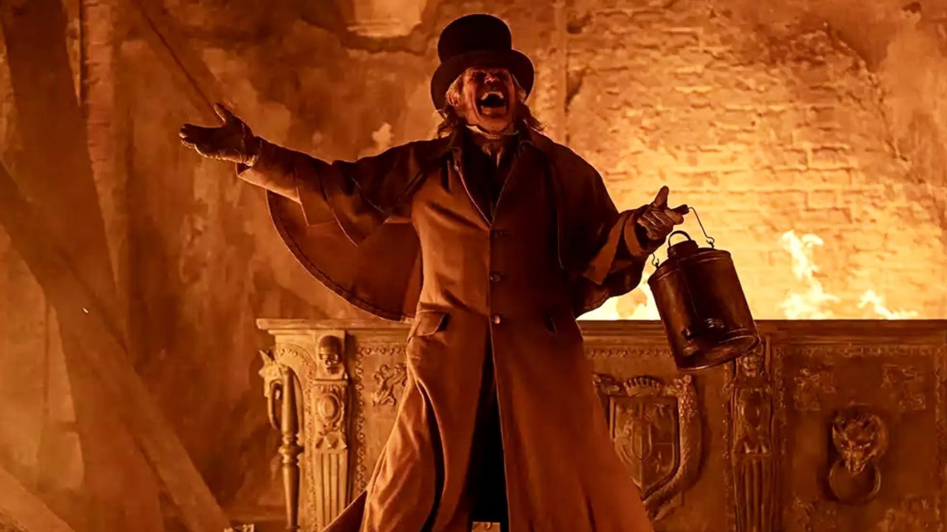 Willem Dafoe stands in front of a burning crypt