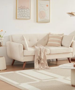 A white couch in a neutral colored living room
