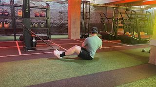 Personal trainer at Gymbox Aaron Cook performing a Russian twist