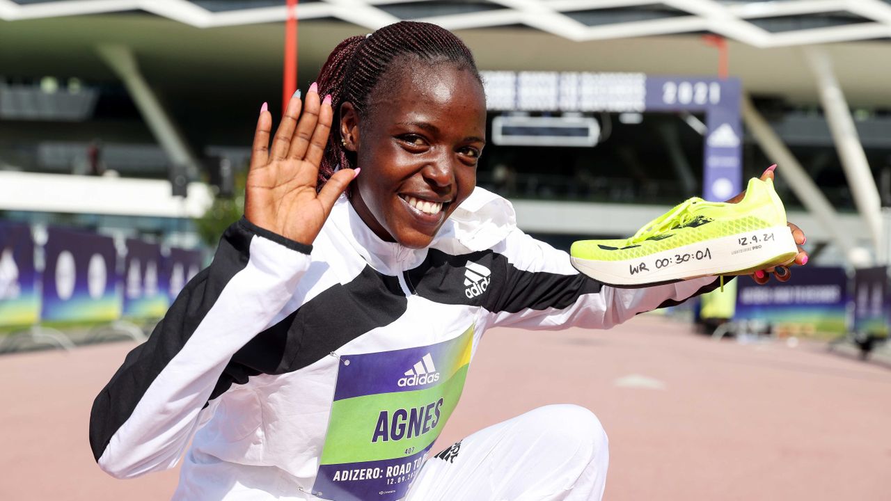 Agnes Jebet Tirop posing with her record breaking shoe at the ADIDAS ADIZERO: ROAD TO RECORDS event in Germany