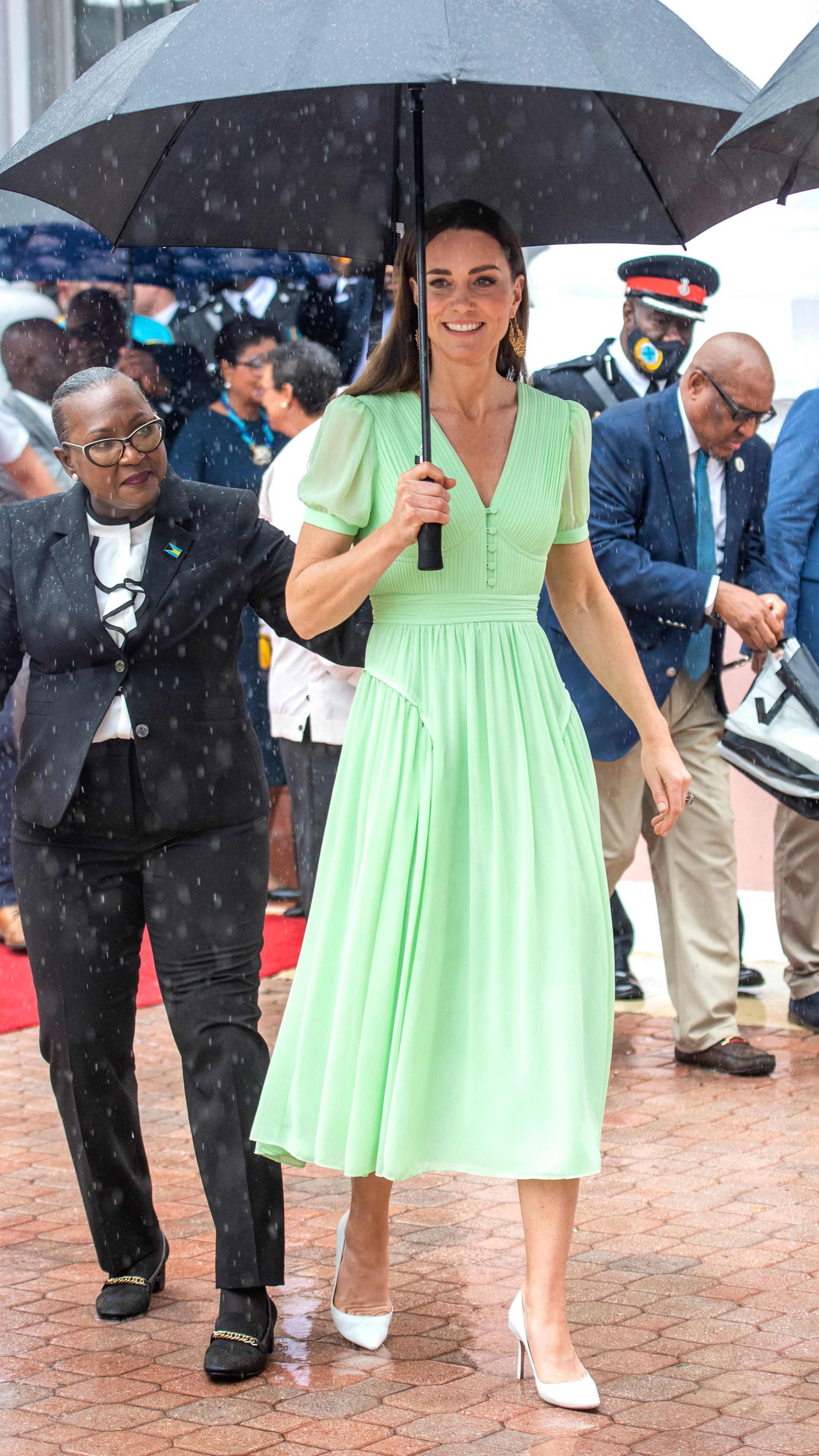 The Princess of Wales holds an umbrella as she attends the traditional Bahamian Jankadoo celebration at Parliament Square on March 25, 2022