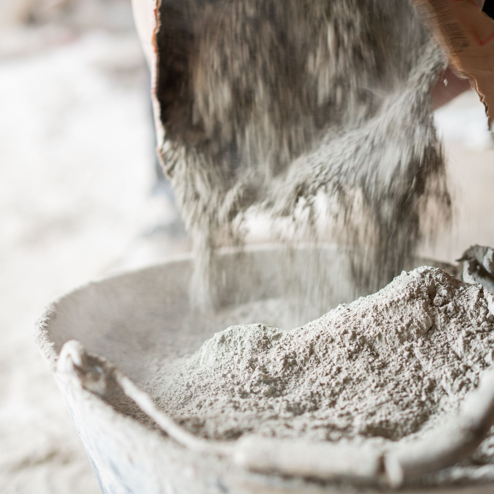 Pouring plaster into a bucket ready for mixing with water