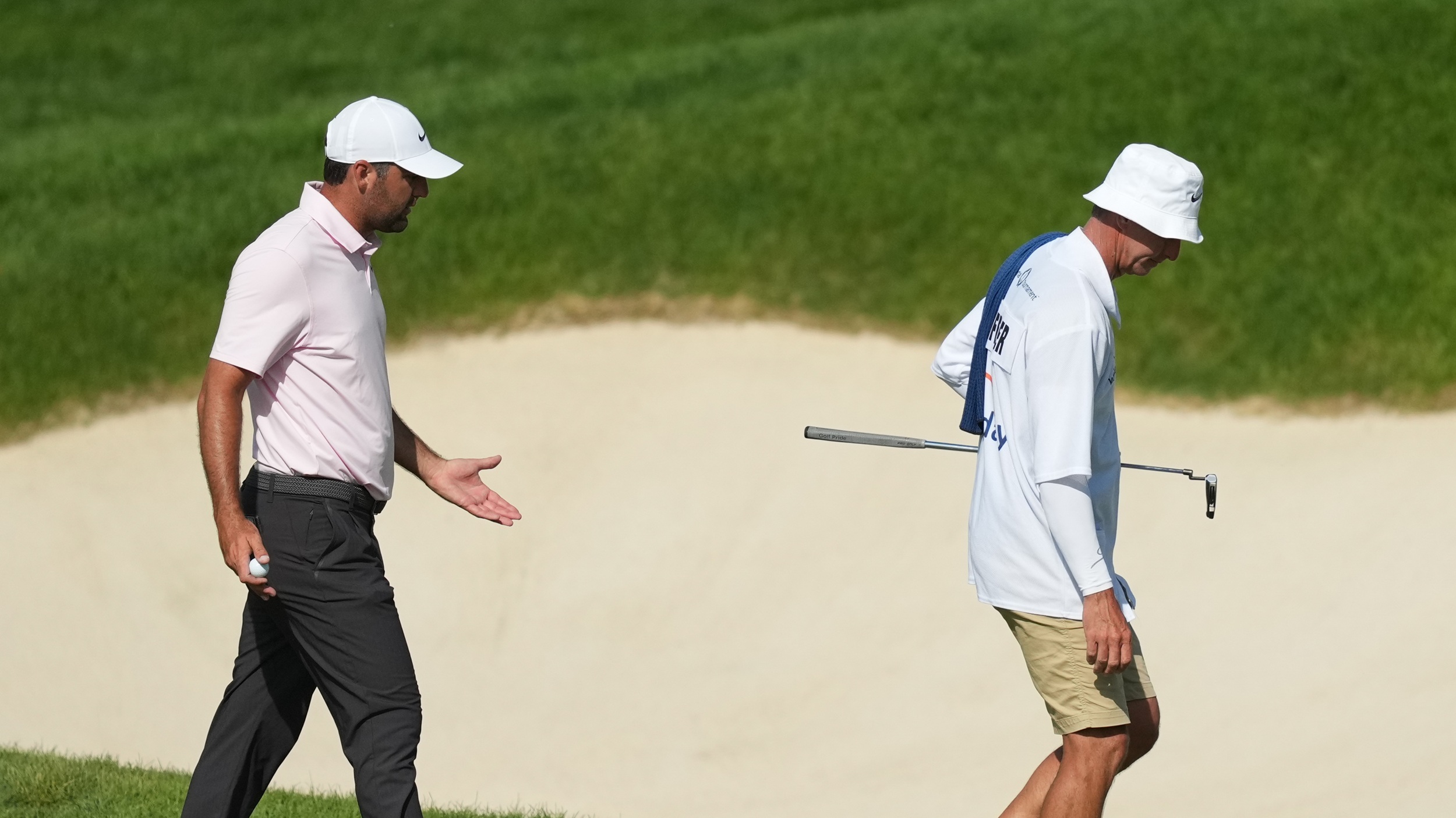 Scottie Scheffler shouts at caddie Ted Scott after hitting a tee shot into the water at the 16th hole at Muirfield Village during the 2026 Memorial Tournament