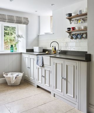 Pale grey kitchen ideas with Shaker cabinetry, open shelving and a butler sink.
