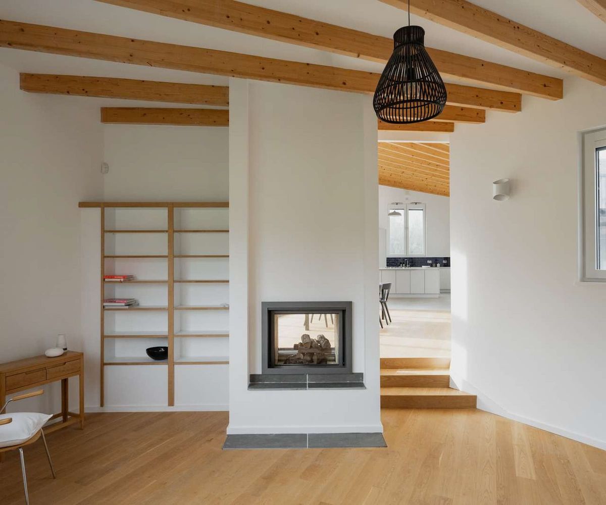 A fireplace in the wall of a white wall
