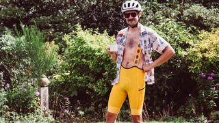 a man in yellow bib shorts and a party shirt