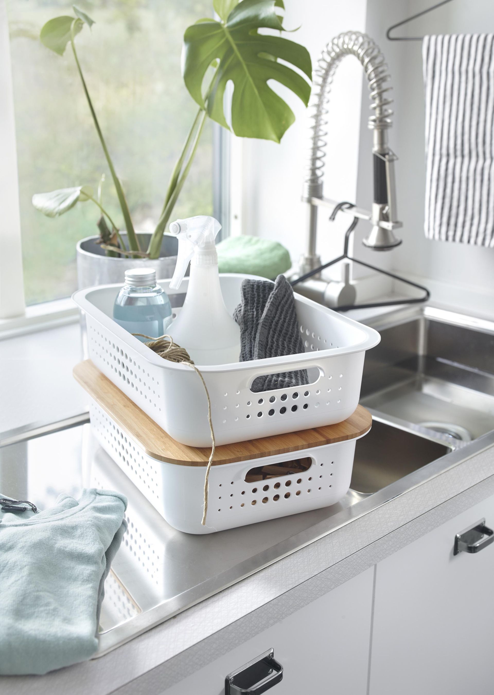 organization for under kitchen sink sitting on countertop