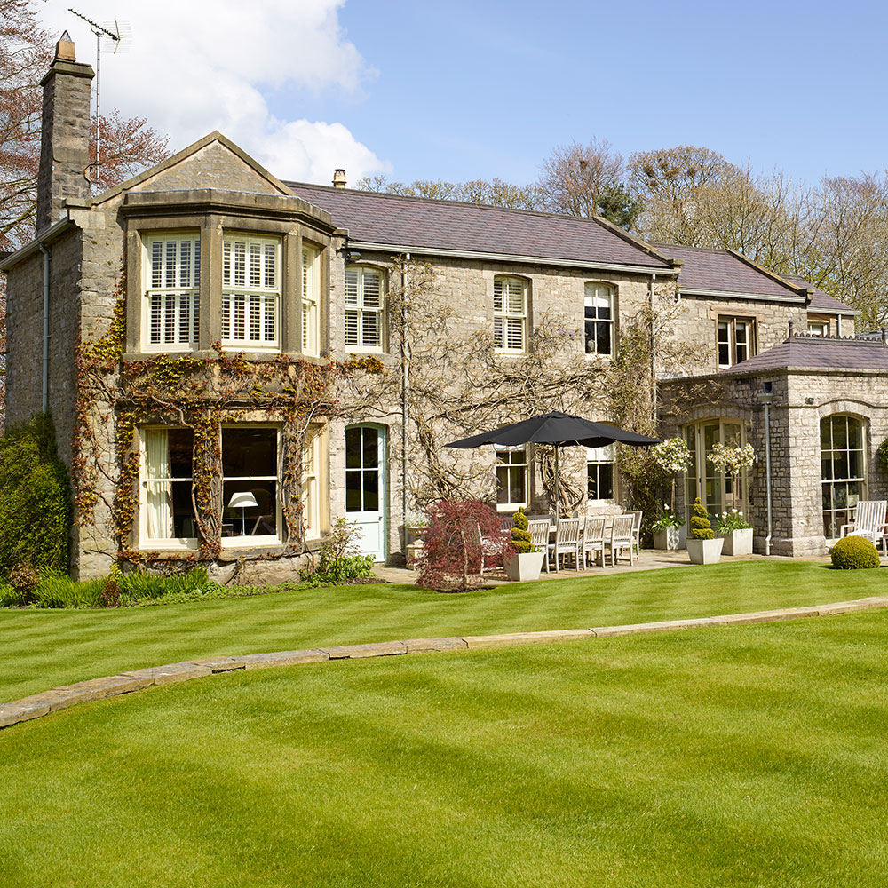 Exterior of house with garden and white windows