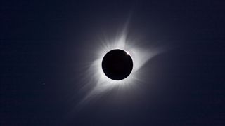 A composite of the August 21, 2017 total solar eclipse showing third contact – the end of totality – with sunlight beginning to reappear and the array of pink prominences along the limb of the Sun Seconds later the emerging Sun and diamond ring overwhelmed the large prominence Regulus is at lower left This is a composite of two images taken seconds apart: a 1/15th second exposure for the corona and a 1/1000 sec exposure for the prominences and chromosphere Taken with the 106mm Astro-Physics apo refractor at f/5 and Canon 6D MkII camera at ISO 100 On the Mach One equatorial mount, polar aligned and tracking the sky. (Photo by: Alan Dyer/VW Pics/UIG via Getty Images)