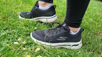 Close up of Skechers GOWalk Arch Fit Motion Breeze shoes worn by person