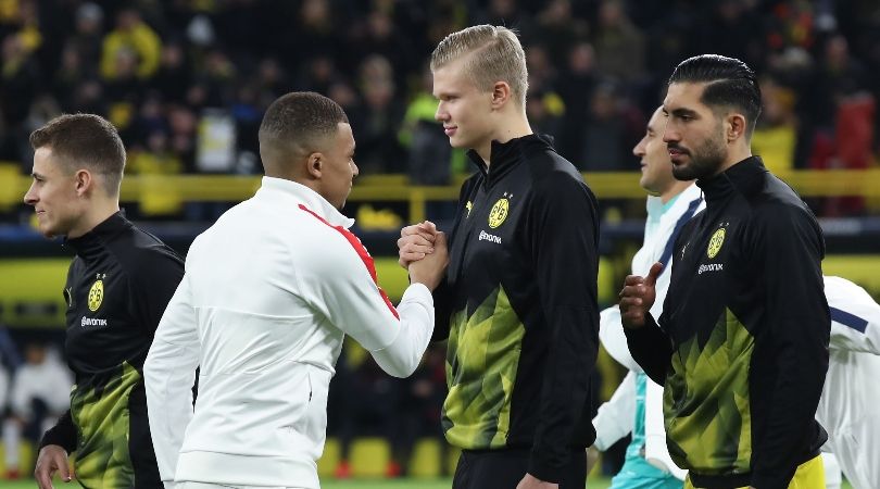 Kylian Mbappe of PSG greets Borussia Dortmund&#039;s Erling Haaland.