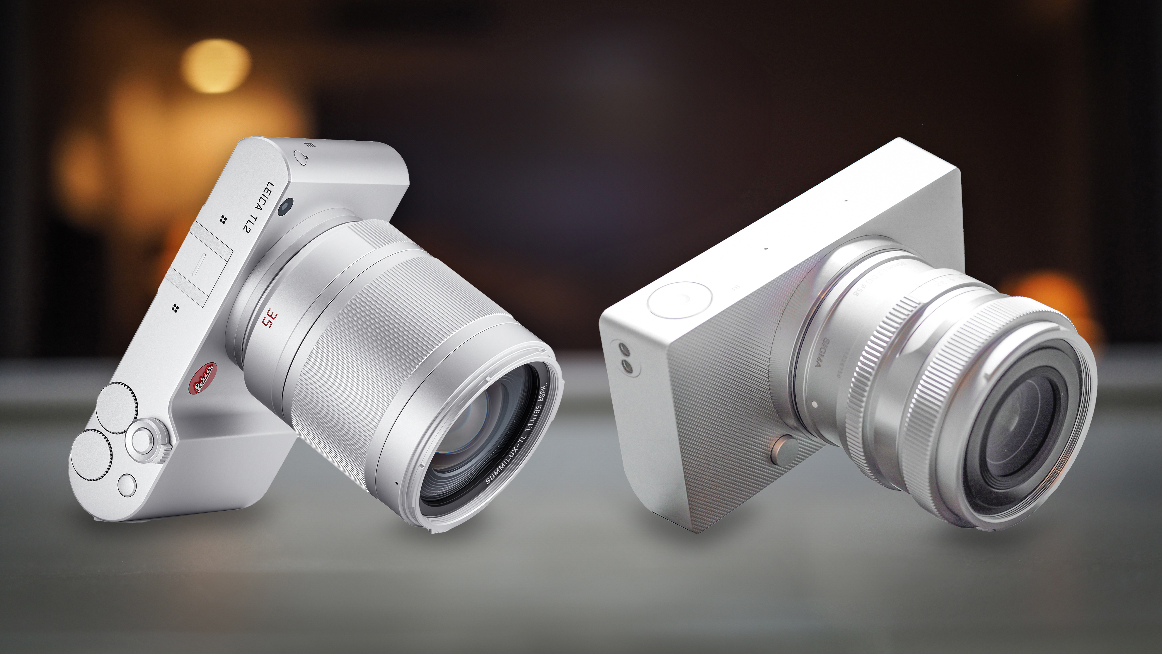 Leica TL2 next to a Sigma BF on a grey surface
