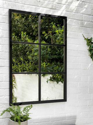 large garden mirror on a white wall