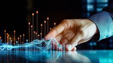 A man seems to touch a digital graph, making it grow.