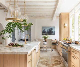 Wooden kitchen with white marble countertops and rustic fixtures