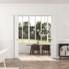 White living room with pocket door leading to dining space