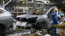Workers assemble a vehicle on the production line at the Subaru Gunma Yajima Plant in Ota, Japan