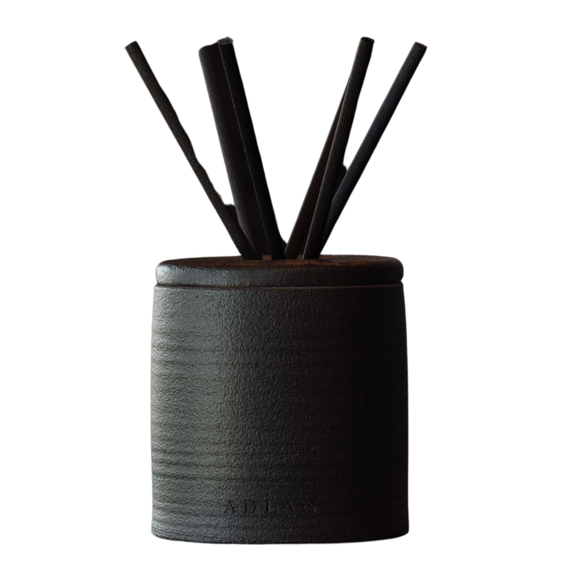 A black Adlan fragrances reed diffuser with black reeds